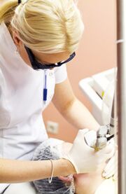 The doctor performs a photothermolysis procedure