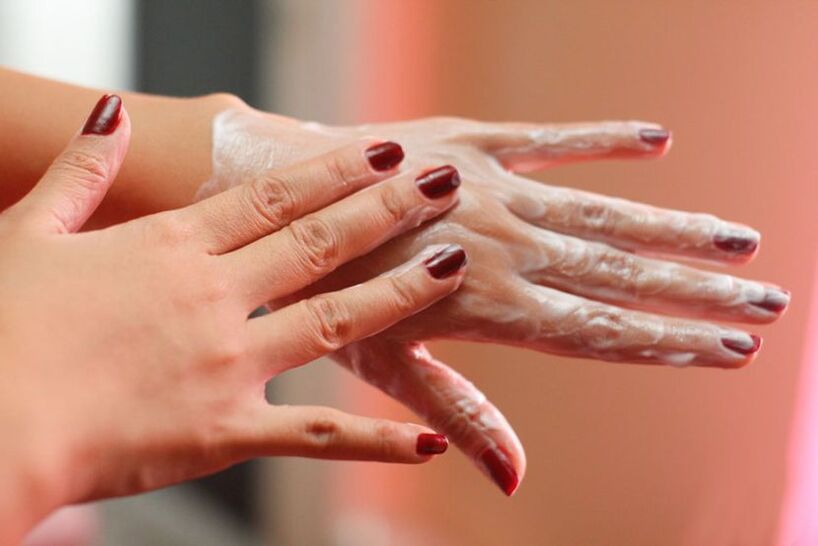 applying cream on the hands to rejuvenate the skin